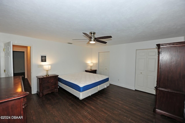 bedroom with dark wood-type flooring and ceiling fan