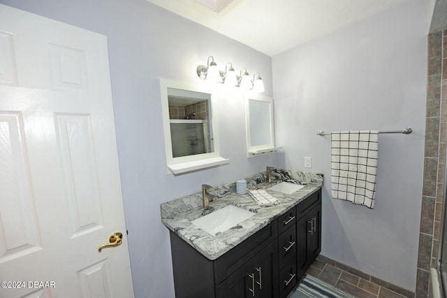 bathroom featuring a shower and vanity