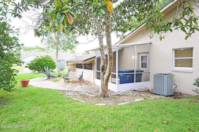 1889 Seclusion Dr, Port Orange, FL 32128 - view of green lawn with a sunroom and central AC unit