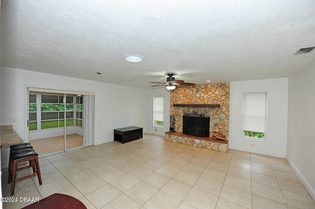 1889 Seclusion Dr, Port Orange, FL 32128 - unfurnished living room with light tile patterned flooring, ceiling fan, a fireplace, and baseboards