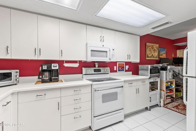kitchen with white cabinetry, white appliances, light countertops, and visible vents