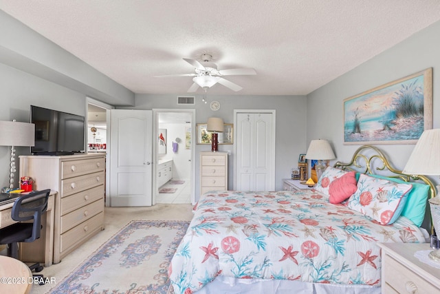 bedroom with light colored carpet, a closet, a textured ceiling, and visible vents