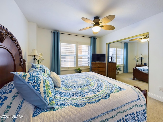 carpeted bedroom with a closet and ceiling fan