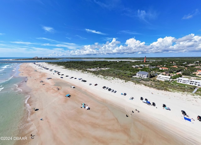 birds eye view of property featuring a water view and a beach view