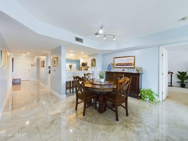 dining room featuring a textured ceiling