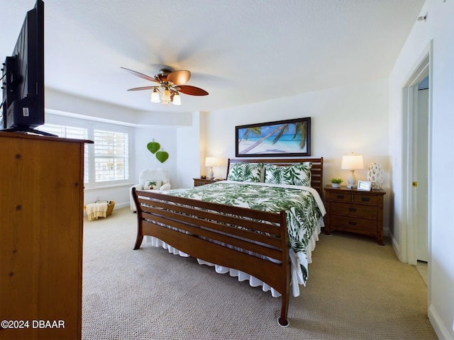 bedroom with light carpet and ceiling fan