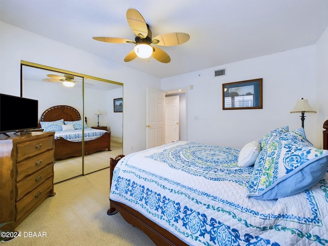 carpeted bedroom with a closet and ceiling fan