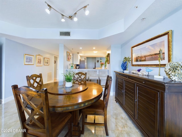 dining area with light tile patterned floors