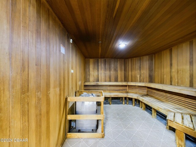 view of sauna / steam room featuring wood walls and wooden ceiling