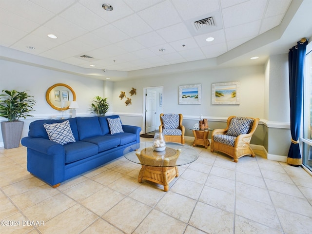 tiled living room featuring a paneled ceiling