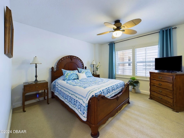 bedroom featuring ceiling fan and light colored carpet