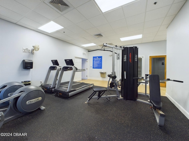 gym with a paneled ceiling