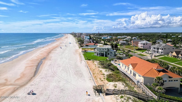 drone / aerial view with a beach view and a water view