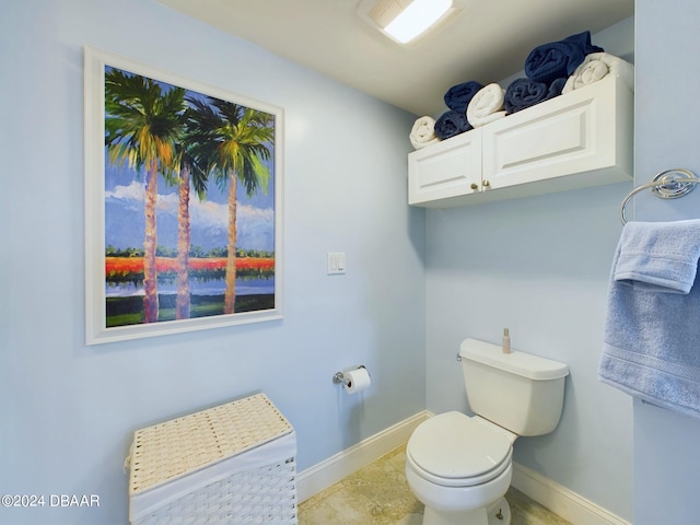 bathroom with toilet and tile patterned floors