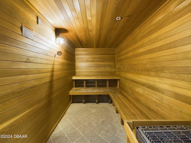 view of sauna featuring wooden walls and wood ceiling