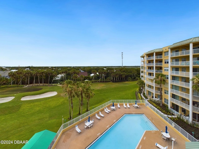 view of pool featuring a lawn