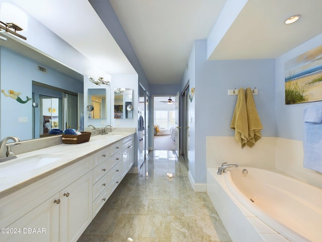 bathroom with vanity, ceiling fan, and a relaxing tiled tub