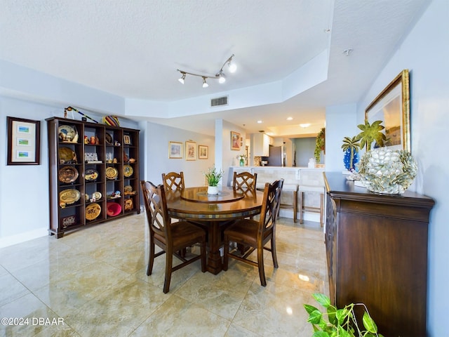 dining room with a textured ceiling