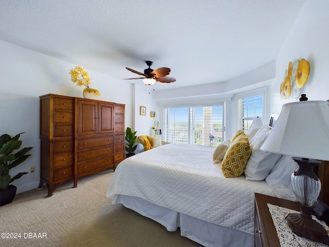 bedroom with ceiling fan and light colored carpet