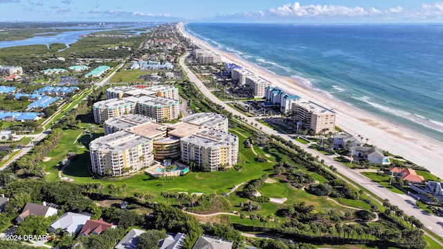 birds eye view of property with a water view and a beach view