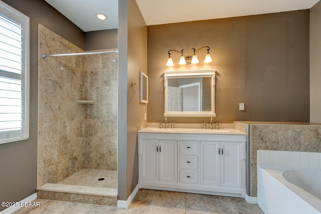 bathroom featuring plenty of natural light, separate shower and tub, and vanity