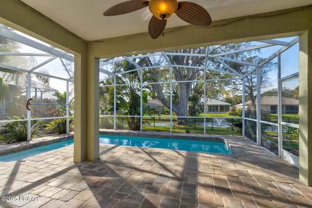 view of pool with a lanai, a patio area, and ceiling fan