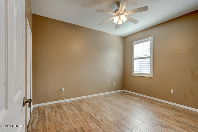 spare room featuring light hardwood / wood-style floors and ceiling fan