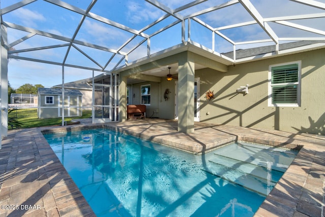 view of pool with a lanai, a shed, and a patio area