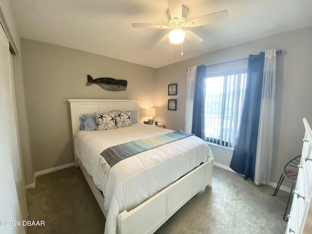 bedroom with ceiling fan and dark colored carpet