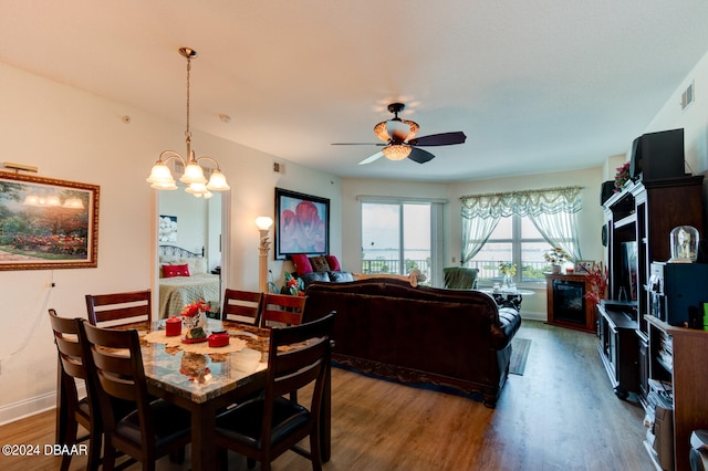 dining area featuring hardwood / wood-style floors and ceiling fan with notable chandelier