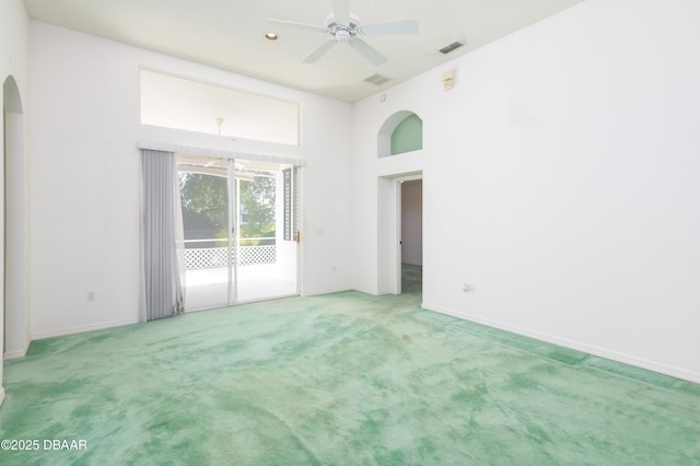 149 Gala Cir, Daytona Beach, FL 32124 - spare room with arched walkways, light colored carpet, a ceiling fan, and baseboards