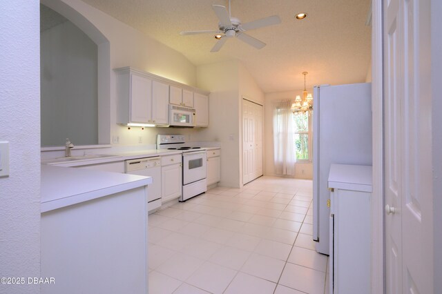 149 Gala Cir, Daytona Beach, FL 32124 - kitchen featuring white appliances, a sink, vaulted ceiling, white cabinetry, and light countertops
