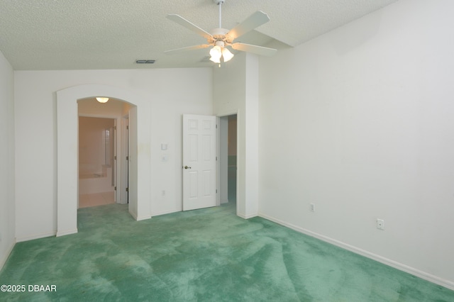 149 Gala Cir, Daytona Beach, FL 32124 - carpeted spare room with arched walkways, ceiling fan, baseboards, a textured ceiling, and lofted ceiling