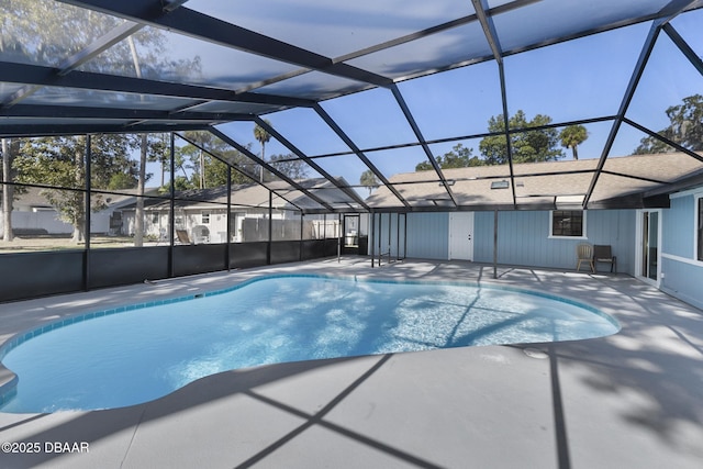 view of swimming pool with a lanai and a patio