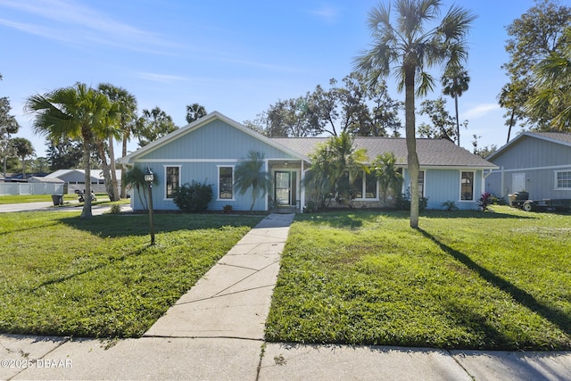 ranch-style home featuring a front yard