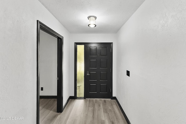 interior space featuring light hardwood / wood-style floors and a textured ceiling