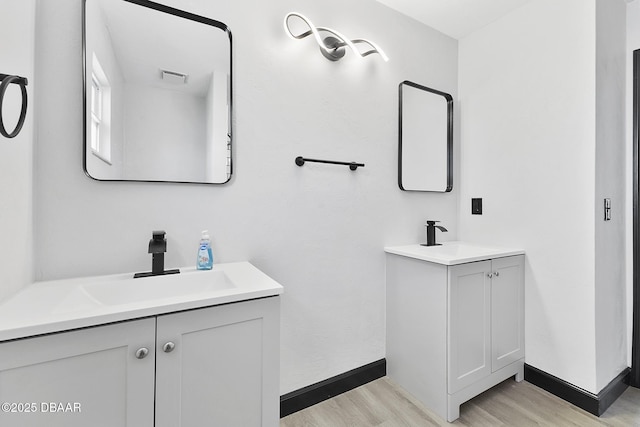 bathroom with hardwood / wood-style floors and vanity