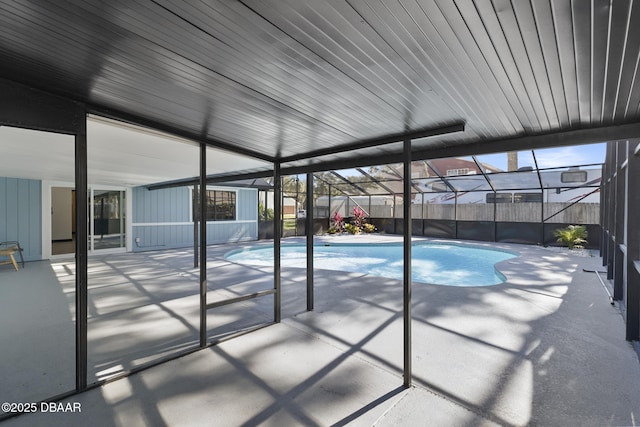 view of pool with a patio and a lanai