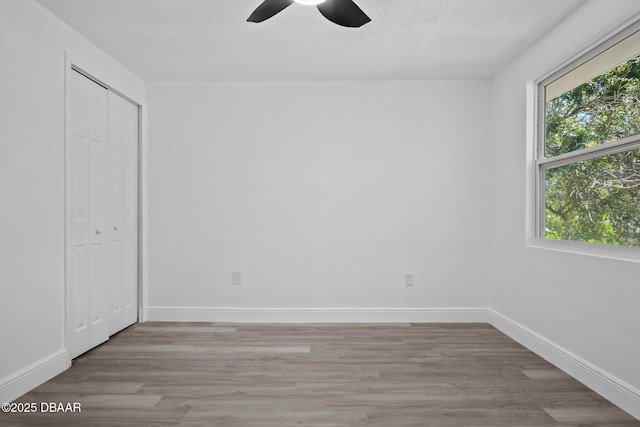 1324 Powers Ave, Holly Hill, FL 32117 - unfurnished bedroom with wood finished floors, a closet, ceiling fan, and a textured ceiling