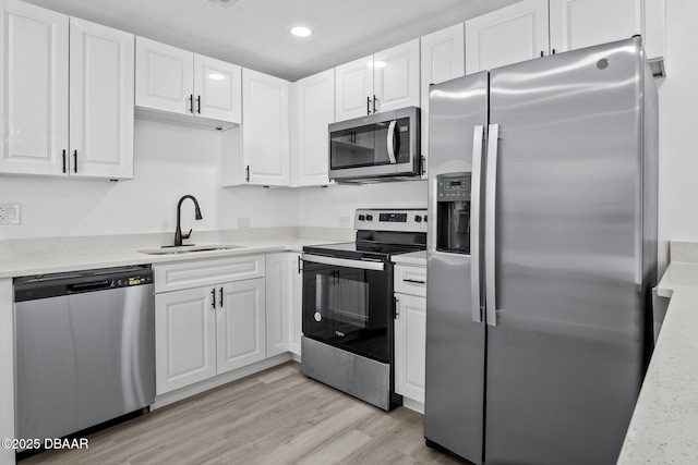 1324 Powers Ave, Holly Hill, FL 32117 - kitchen with appliances with stainless steel finishes, white cabinetry, recessed lighting, light countertops, and light wood finished floors
