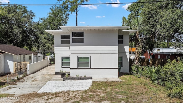 1324 Powers Ave, Holly Hill, FL 32117 - back of house featuring concrete block siding and concrete driveway