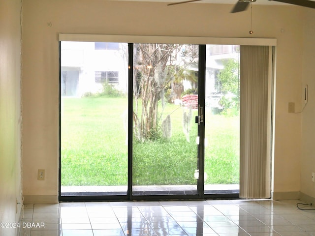 doorway to outside with ceiling fan and light tile patterned floors