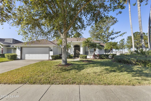 ranch-style house featuring a garage and a front lawn