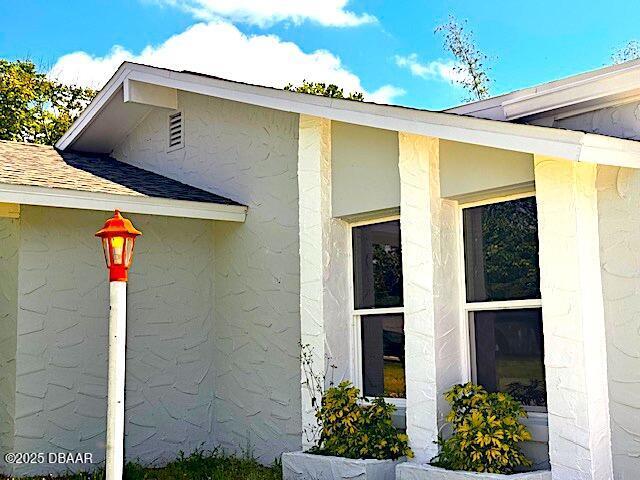 view of exterior entry with stucco siding