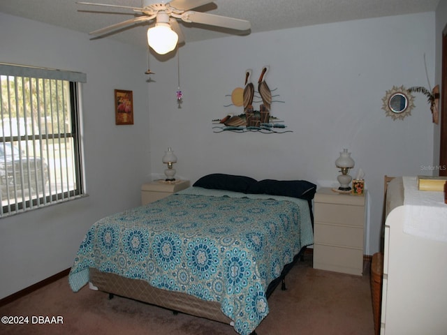 bedroom featuring multiple windows, light carpet, and ceiling fan