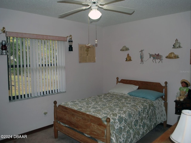 carpeted bedroom with a textured ceiling and ceiling fan