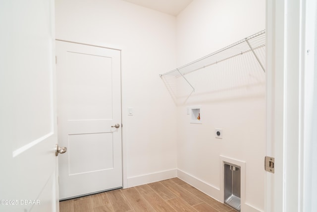 clothes washing area with hookup for a washing machine, light hardwood / wood-style flooring, and hookup for an electric dryer