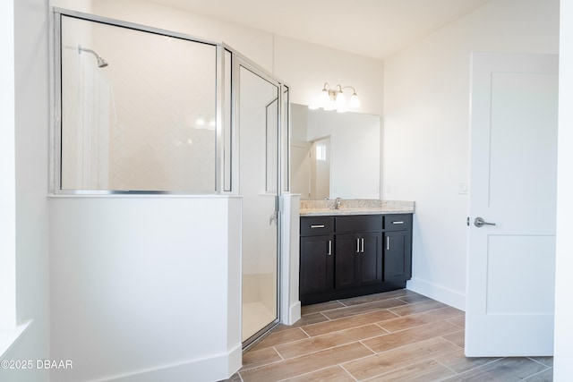 bathroom with vanity and a shower with shower door