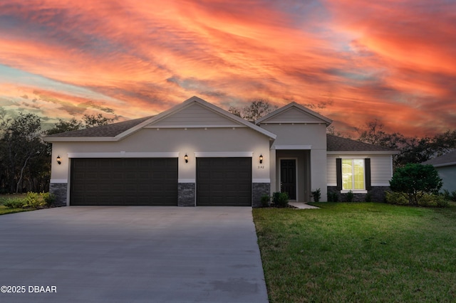 view of front of house with a garage and a lawn