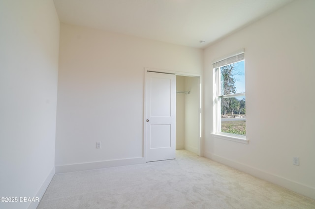 spare room with light colored carpet and a healthy amount of sunlight